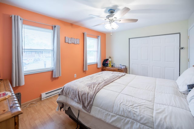 2220 Genevieve Ln, Covington, KY 41011 - bedroom with a baseboard radiator, light wood finished floors, a closet, a ceiling fan, and baseboards