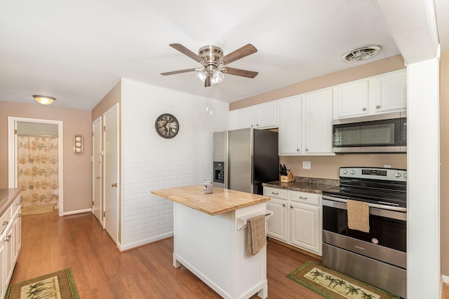 2534 Buttermilk Pike, Fort Mitchell, KY 41017 - kitchen featuring appliances with stainless steel finishes, light wood-style floors, butcher block counters, and white cabinets