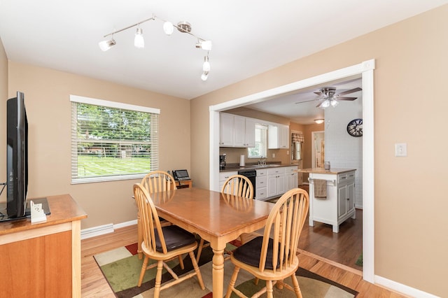 2534 Buttermilk Pike, Fort Mitchell, KY 41017 - dining room featuring light wood-type flooring, a ceiling fan, healthy amount of natural light, and rail lighting