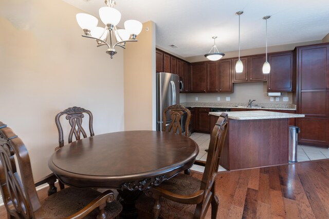 567 Riverpointe Dr Unit 11, Dayton, KY 41074 - dining room with a chandelier and light wood-style floors