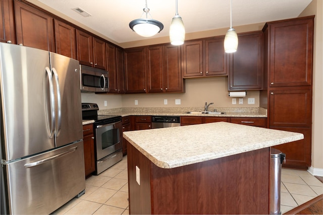 567 Riverpointe Dr Unit 11, Dayton, KY 41074 - kitchen featuring stainless steel appliances, a sink, light tile patterned flooring, light countertops, and pendant lighting