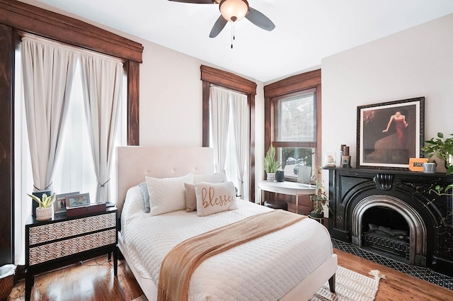 519 Greenup St Unit A, Covington, KY 41011 - bedroom with wood finished floors, ceiling fan, and a fireplace with flush hearth