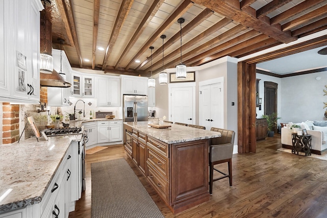 519 Greenup St Unit A, Covington, KY 41011 - kitchen with appliances with stainless steel finishes, dark wood-type flooring, a breakfast bar, white cabinets, and glass insert cabinets