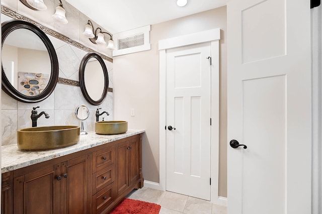 519 Greenup St Unit A, Covington, KY 41011 - full bath featuring decorative backsplash, tile patterned flooring, double vanity, and baseboards