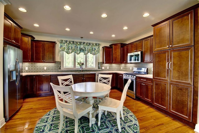 3257 Ivy Ridge Dr, Taylor Mill, KY 41015 - kitchen featuring stainless steel appliances, crown molding, light wood finished floors, a sink, and recessed lighting