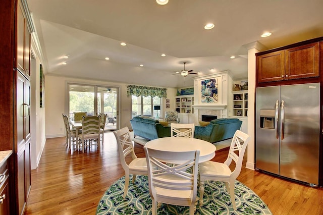 3257 Ivy Ridge Dr, Taylor Mill, KY 41015 - dining space with light wood-type flooring, a fireplace, baseboards, a ceiling fan, and recessed lighting