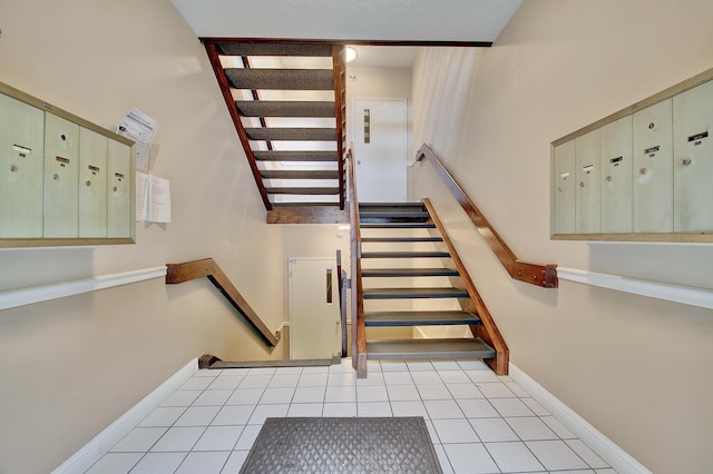370 Timber Ridge Dr Unit 3, Wilder, KY 41071 - stairs featuring mail area, baseboards, and tile patterned flooring