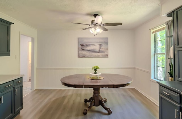 6740 Wisdom Dock Rd, Albany, KY 42602 - dining area with light wood finished floors, a ceiling fan, wainscoting, baseboards, and a textured ceiling