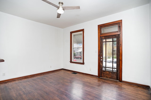 empty room featuring wood finished floors, ceiling fan, and baseboards