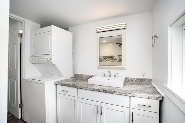 laundry room with estacked washer and dryer