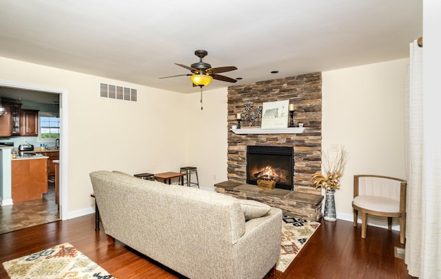 14492 Stephenson Rd, Morning View, KY 41063 - living area with a ceiling fan, wood finished floors, a stone fireplace, and baseboards