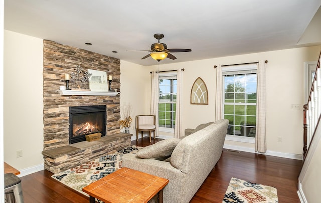 14492 Stephenson Rd, Morning View, KY 41063 - living room featuring wood finished floors, a stone fireplace, a ceiling fan, and baseboards