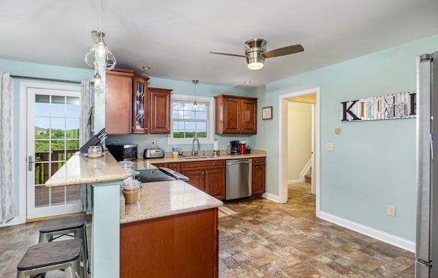 14492 Stephenson Rd, Morning View, KY 41063 - kitchen featuring appliances with stainless steel finishes, a sink, brown cabinets, a kitchen breakfast bar, and ceiling fan