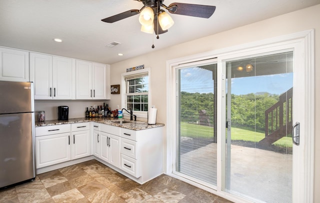 14492 Stephenson Rd, Morning View, KY 41063 - kitchen featuring freestanding refrigerator, a sink, stone countertops, and white cabinetry