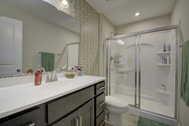 2422 Arezzo St, Covington, KY 41017 - full bath featuring wallpapered walls, a stall shower, toilet, vanity, and wood finished floors