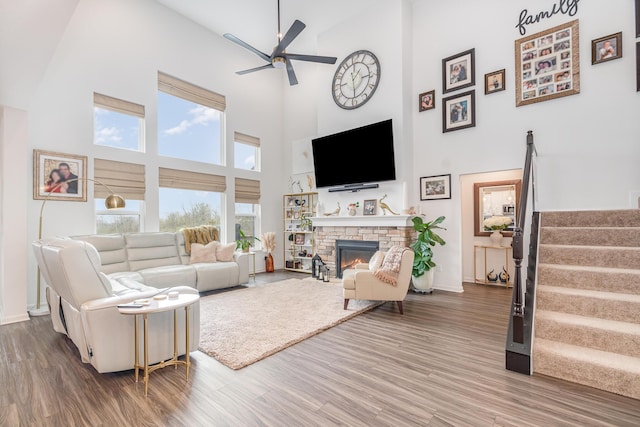 10988 Dairybarn Ln, Alexandria, KY 41001 - living room featuring a high ceiling, ceiling fan, stairs, wood finished floors, and a fireplace