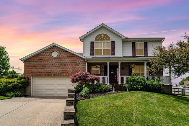 1051 Apple Blossom Dr, Florence, KY 41042 - traditional-style home featuring driveway, brick siding, a lawn, and covered porch