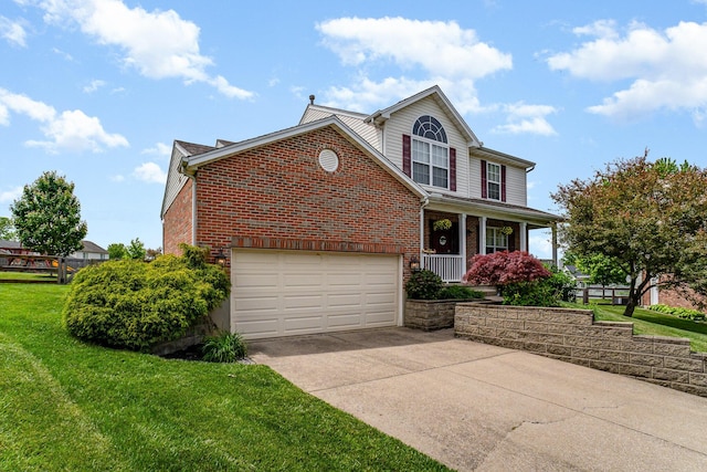 1051 Apple Blossom Dr, Florence, KY 41042 - traditional home with concrete driveway, covered porch, brick siding, a front lawn, and a garage