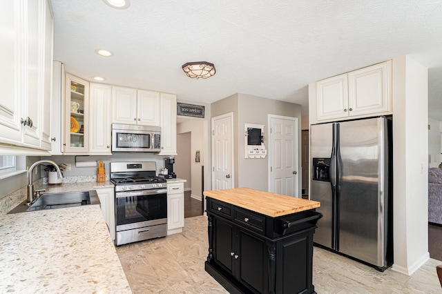 1051 Apple Blossom Dr, Florence, KY 41042 - kitchen featuring appliances with stainless steel finishes, dark cabinetry, a sink, white cabinetry, and recessed lighting