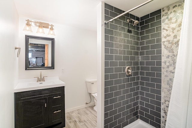1051 Apple Blossom Dr, Florence, KY 41042 - bathroom featuring tiled shower, toilet, vanity, baseboards, and wood finished floors