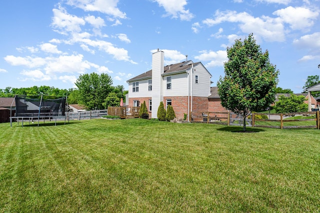 1051 Apple Blossom Dr, Florence, KY 41042 - rear view of property with a trampoline, brick siding, a deck, and a chimney