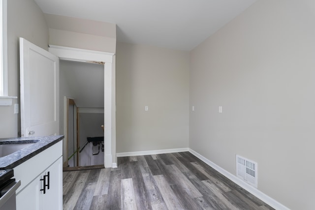 2789 Madison Ave, Covington, KY 41015 - unfurnished dining area featuring dark wood-type flooring and baseboards