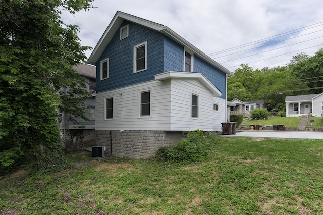 2789 Madison Ave, Covington, KY 41015 - view of side of home with a lawn and central AC