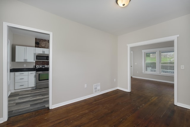 2789 Madison Ave, Covington, KY 41015 - spare room with dark wood-style flooring and baseboards