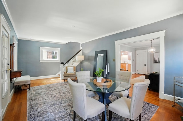 1126 Audubon Rd, Park Hills, KY 41011 - dining room featuring stairs, crown molding, wood finished floors, and baseboards