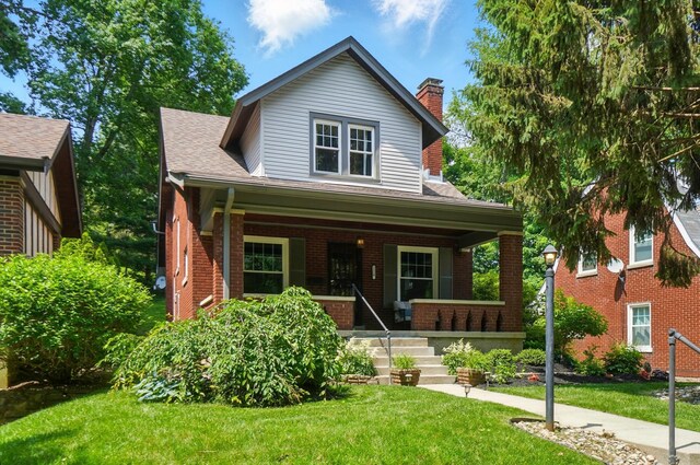 1126 Audubon Rd, Park Hills, KY 41011 - view of front of home featuring a porch, a front lawn, brick siding, a chimney, and a shingled roof