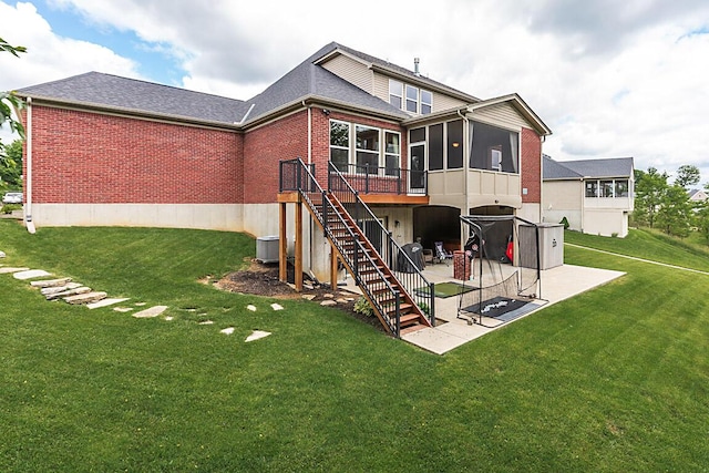 1514 Twinridge Way, Independence, KY 41051 - back of house featuring a patio, a sunroom, brick siding, and a lawn