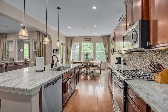 1514 Twinridge Way, Independence, KY 41051 - kitchen featuring stainless steel appliances, a sink, tasteful backsplash, an island with sink, and light stone counters