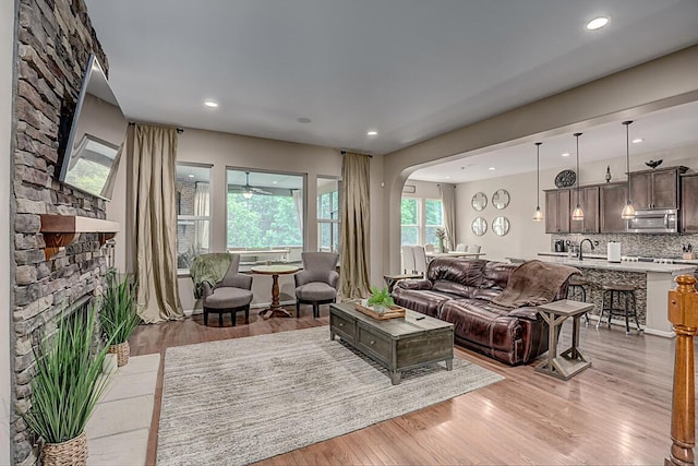 1514 Twinridge Way, Independence, KY 41051 - living area featuring a stone fireplace, arched walkways, light wood-style floors, and recessed lighting