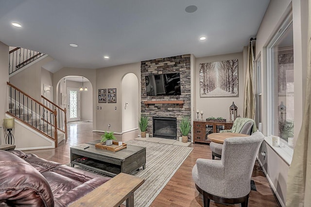 1514 Twinridge Way, Independence, KY 41051 - living area featuring arched walkways, stairway, a stone fireplace, wood finished floors, and recessed lighting