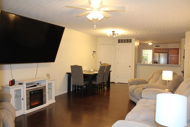 515 Telescope Vw Unit 103, Wilder, KY 41076 - living room featuring a ceiling fan, dark wood finished floors, a warm lit fireplace, a textured ceiling, and baseboards