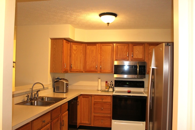 515 Telescope Vw Unit 103, Wilder, KY 41076 - kitchen featuring appliances with stainless steel finishes, a sink, light countertops, and brown cabinetry
