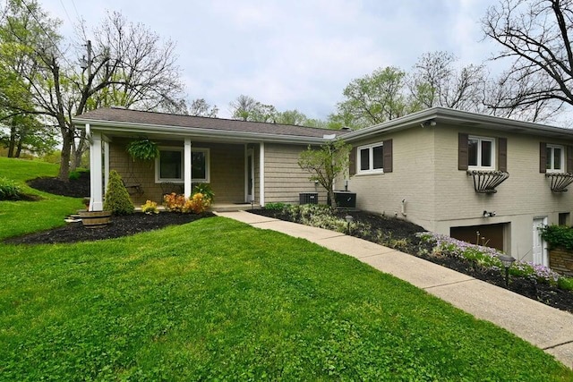 871 Bristow Rd, Independence, KY 41051 - view of front facade with a garage, a front lawn, covered porch, and central AC