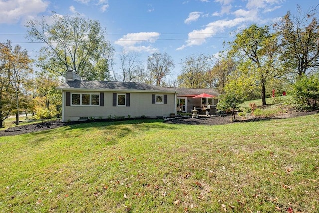 871 Bristow Rd, Independence, KY 41051 - back of property featuring a lawn, a chimney, and a patio area