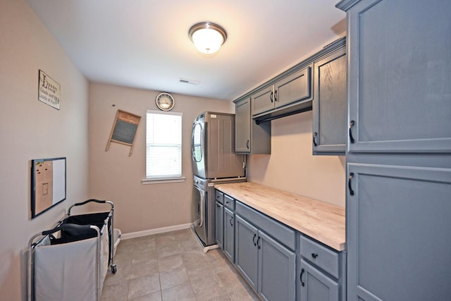 10113 Lapalco Ct, Union, KY 41091 - kitchen with estacked washer and dryer, gray cabinetry, light countertops, baseboards, and light tile patterned floors