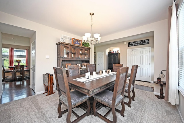 10113 Lapalco Ct, Union, KY 41091 - dining space featuring a chandelier, dark colored carpet, baseboards, and arched walkways