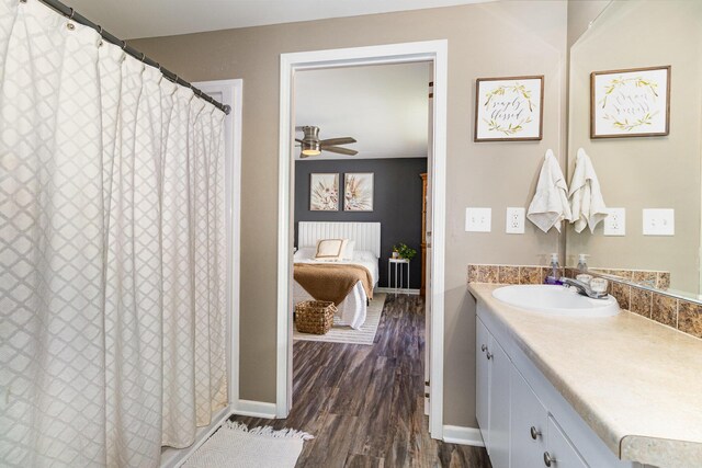 566 Sycamore St, Crescent Springs, KY 41017 - full bathroom featuring wood finished floors, vanity, ceiling fan, and baseboards