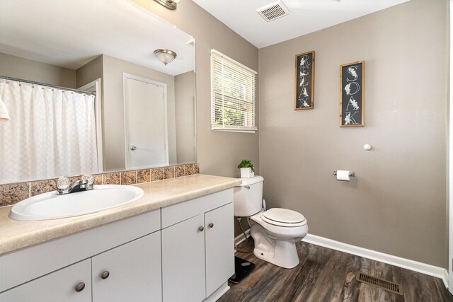 566 Sycamore St, Crescent Springs, KY 41017 - bathroom with toilet, vanity, baseboards, and wood finished floors
