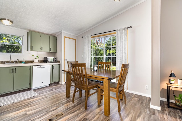 566 Sycamore St, Crescent Springs, KY 41017 - dining area with crown molding, light wood-style flooring, lofted ceiling, a textured ceiling, and baseboards