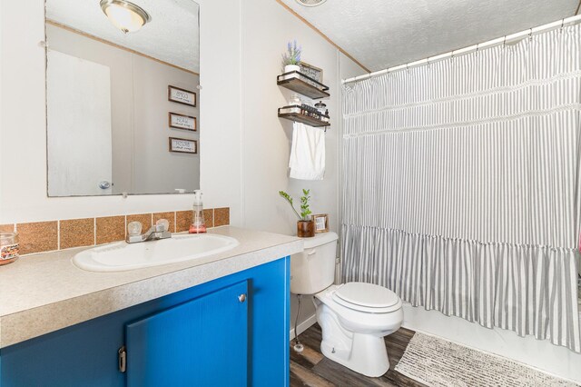 566 Sycamore St, Crescent Springs, KY 41017 - bathroom featuring toilet, vanity, a textured ceiling, wood finished floors, and tasteful backsplash