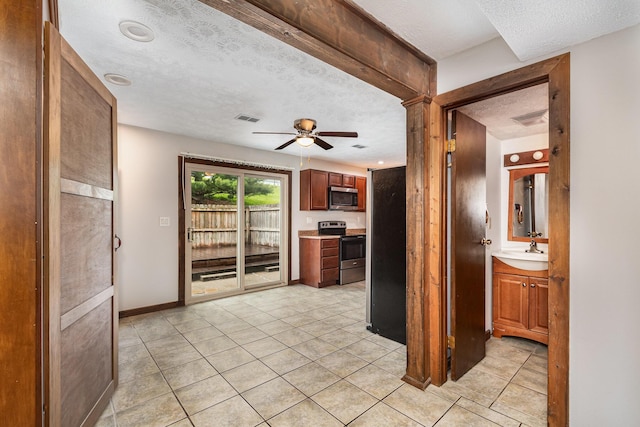 6753 Curtis Way, Florence, KY 41042 - kitchen with stainless steel appliances, a textured ceiling, ceiling fan, a sink, and light tile patterned flooring