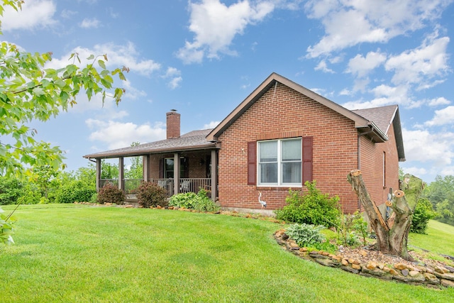 1019 Fisher Rd, Foster, KY 41043 - back of house featuring a chimney, brick siding, a yard, and covered porch