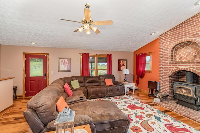 1019 Fisher Rd, Foster, KY 41043 - living room with a wood stove, a textured ceiling, plenty of natural light, wood finished floors, and ceiling fan