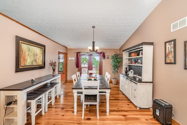 1019 Fisher Rd, Foster, KY 41043 - dining space featuring a chandelier, light wood-style floors, a textured ceiling, and baseboards