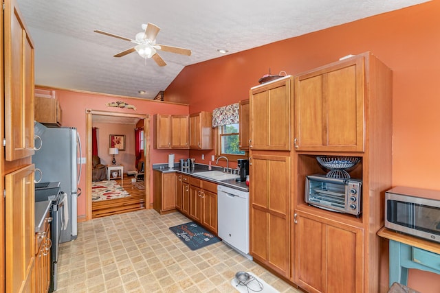 1019 Fisher Rd, Foster, KY 41043 - kitchen with stainless steel appliances, a sink, a ceiling fan, lofted ceiling, and brown cabinets