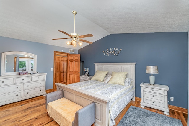 1019 Fisher Rd, Foster, KY 41043 - bedroom featuring wood finished floors, lofted ceiling, a ceiling fan, baseboards, and a textured ceiling